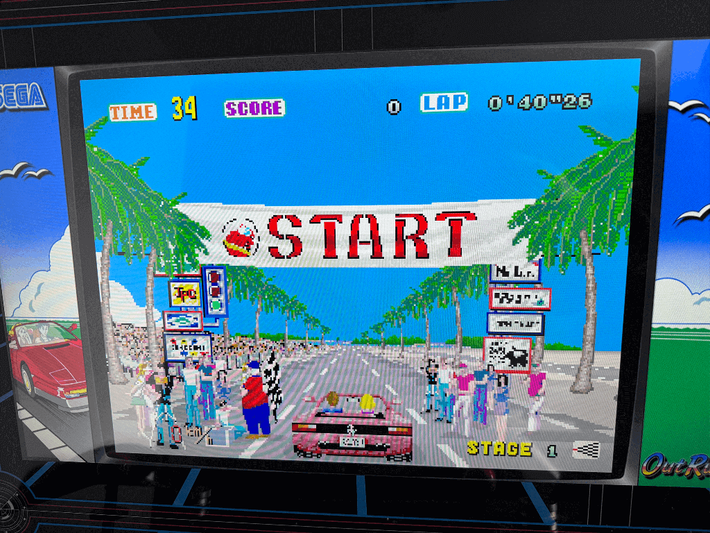 A close up of an arcade playing the Outrun arcade game.