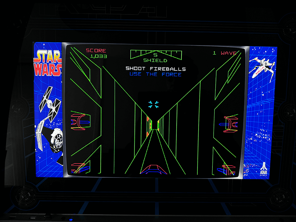 A close up of an arcade playing the Star Wars arcade game.