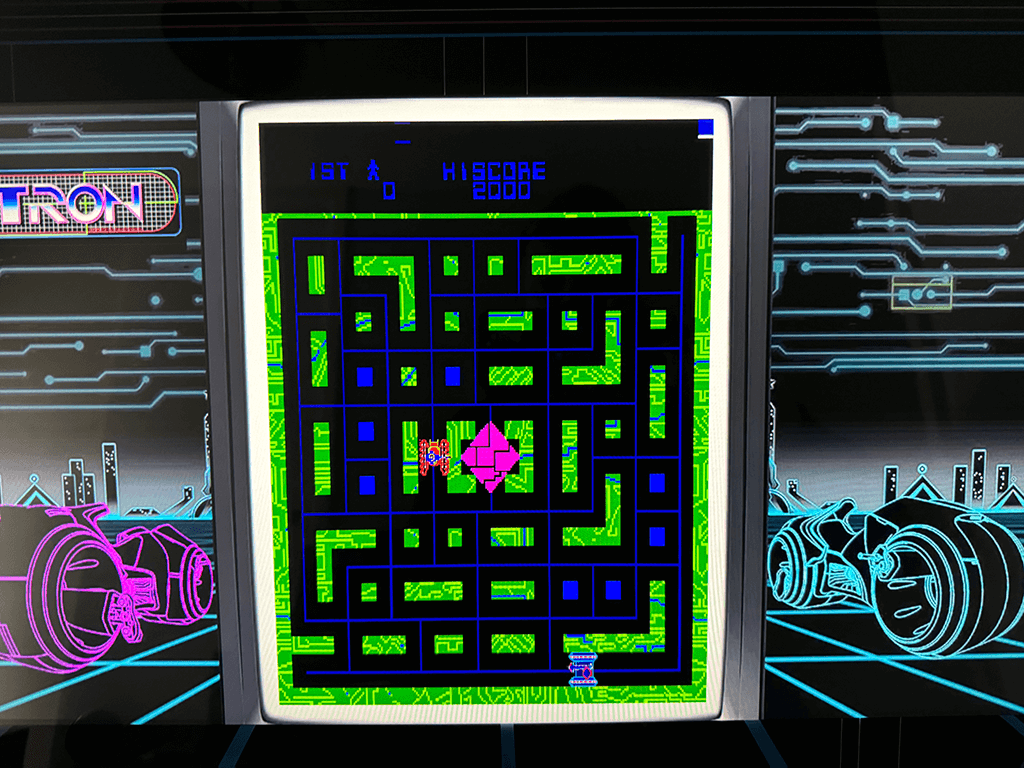 A close up of an arcade playing the Tron arcade game.