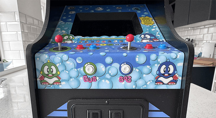 A Bubble Bobble quarter arcade cabinet on a quartz worktop surface in a kitchen.