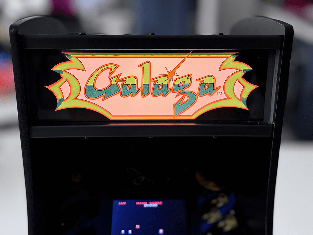 A Galaga Quarter Arcade close up showing a lit Marquee and game playing.